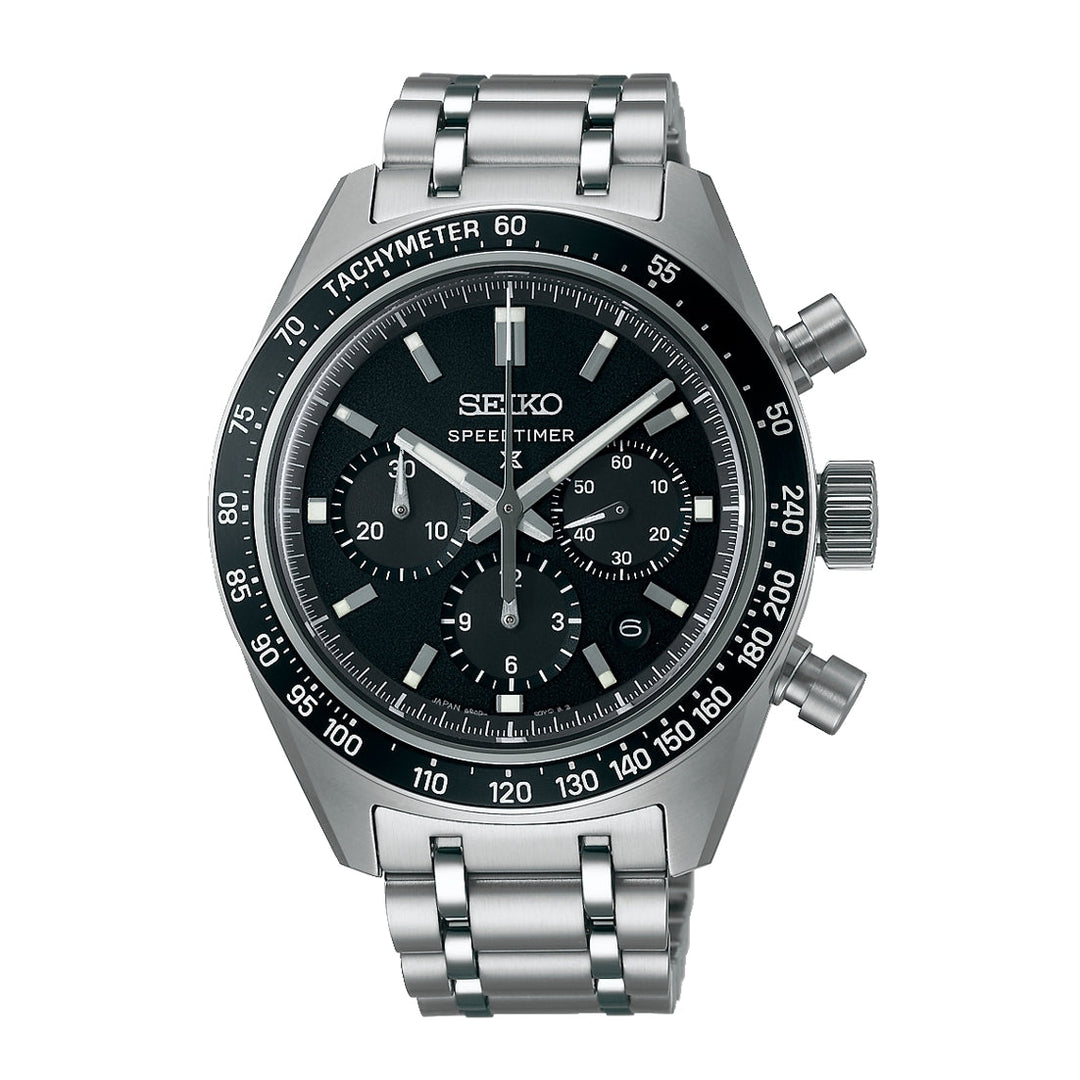 Seiko watch with black dial and silver metal strap on a white background
